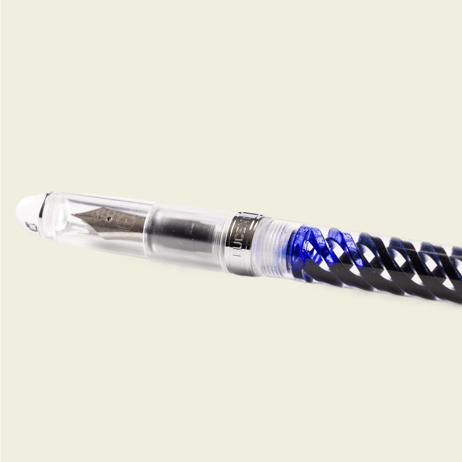 Half view of inked Triple Twist Lucent fountain pen showing the capped side, by Hex Pens.